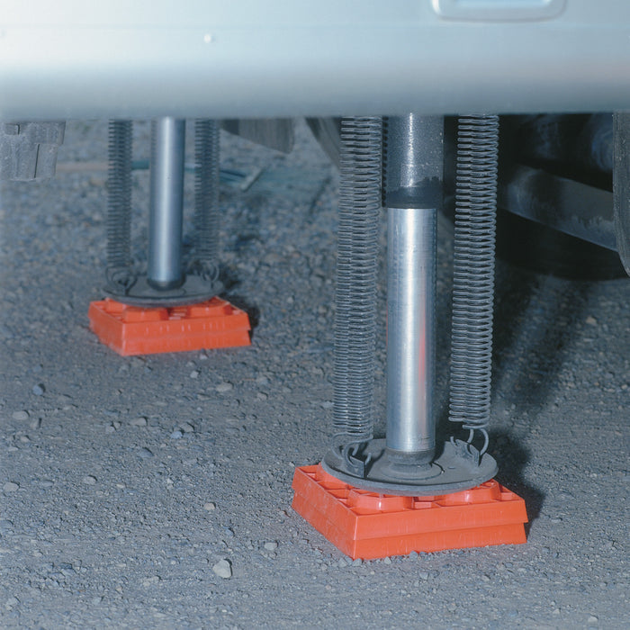 Orange Lynx Levelers Supporting RV Stabilizer Jacks - Underside View | United RV Parts