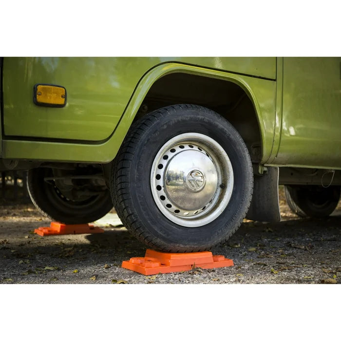 Orange Lynx Levelers Under Green RV Wheel - In Use Lifestyle Shot | United RV Parts