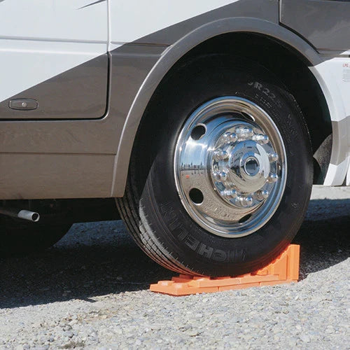 Orange RV Wheel Chock - Close-up Detail Under Tire | United RV Parts