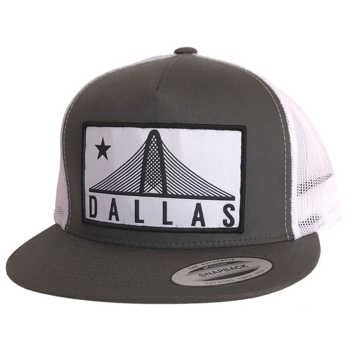 Trinity Dallas Patched Flat Bill Hat featuring a gray and white design, ideal for showcasing Texas pride. A great Texas themed gift and perfect for anyone looking for stylish Texas Made Gifts. This hat serves as a unique souvenir from Texas, making it an excellent dallas souvenir or texan gift.