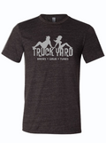 Dark, charcoal gray tshirt with graphic design of the Truck Yard logo with the silhouette of a man and a woman on top.