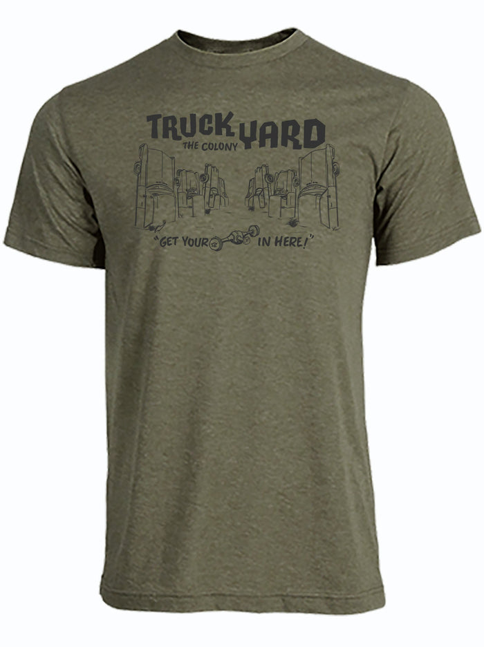 Olive green tshirt with a graphic design of cars sticking up from the ground and the Truck Yard The Colony Logo in black letters.