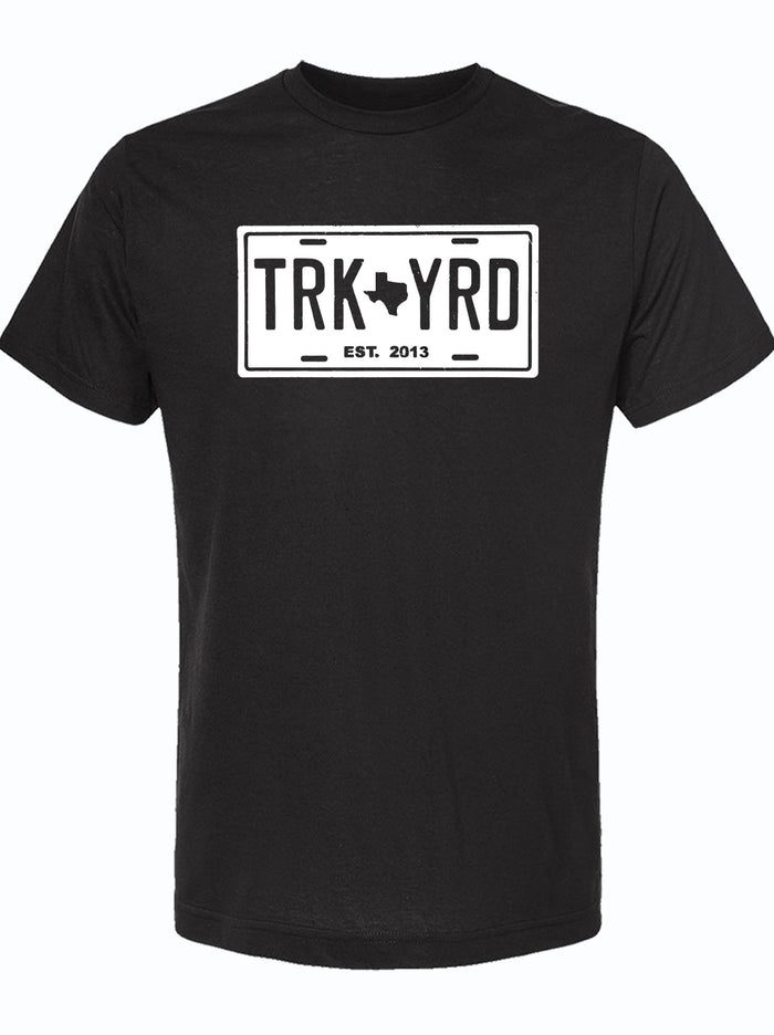 Black tshirt with a white graphic design of a license plate that reads "TRK YRD" with a Texas in the center.