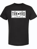 Black tshirt with a white graphic design of a license plate that reads "TRK YRD" with a Texas in the center.