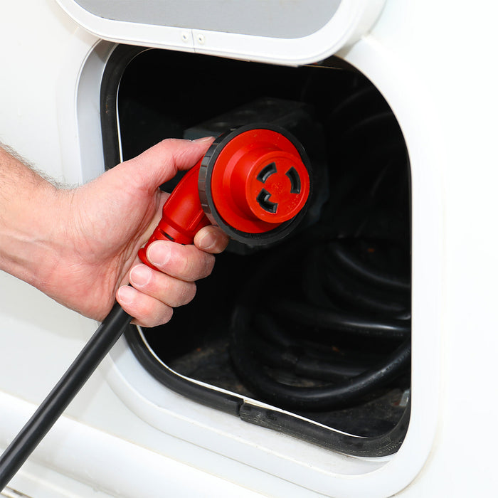 Red 30 Amp Female RV Power Connector Being Plugged into Shore Power Outlet | United RV Parts