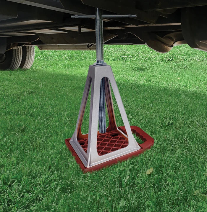 Valterra StayPut RV Stabilizer Jack Pad In Use Under RV on Grass - Side View | United RV Parts