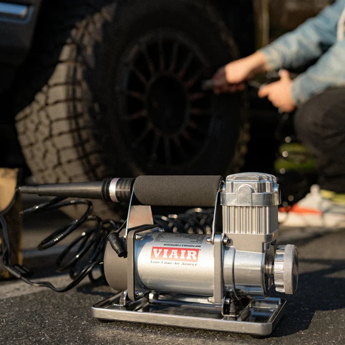 Silver Viair 300P RVS Portable Air Compressor on Ground Next to RV Tire - Lifestyle | United RV Parts